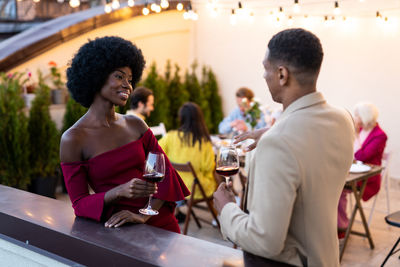 Side view of young woman sitting at restaurant