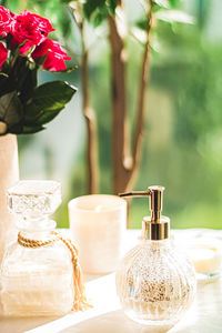 Close-up of white roses in vase on table