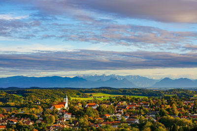 Town by mountains against sky