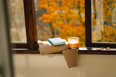 Sweater, candle and autumn decor. autumn home decor.