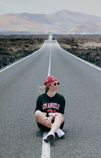 Rear view of man walking on road