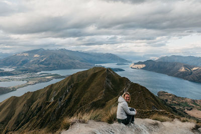 Rear view of woman standing on cliff