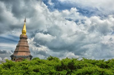 Low angle view of building against cloudy sky