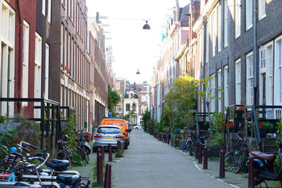 Cars on street amidst buildings in city
