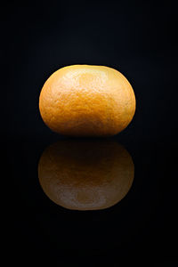 Close-up of orange over black background