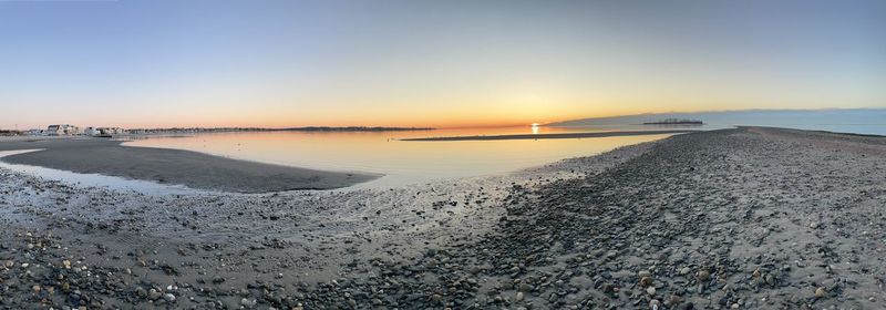 Scenic view of beach against sky during sunset