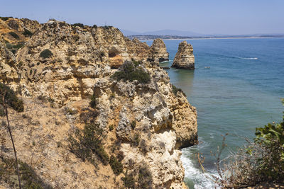 Panoramic view of rock formation in sea against clear sky