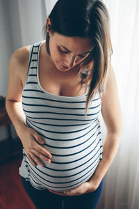 High angle view of pregnant woman standing at home