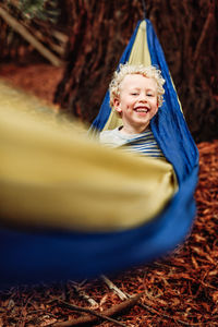 Portrait of happy boy playing in playground