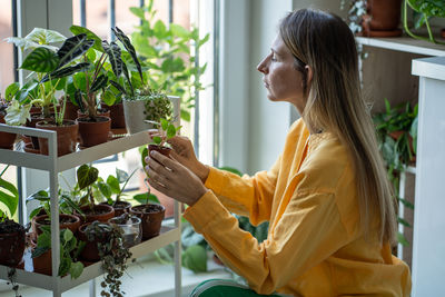 Young woman holding potted plant