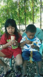 Happy siblings playing in park