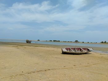 A stranded boat on the beach sand