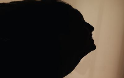 Close-up portrait of silhouette man against sky