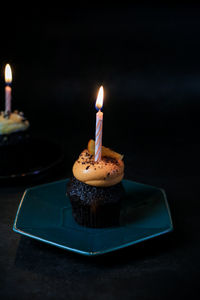 Close-up of illuminated candles on table