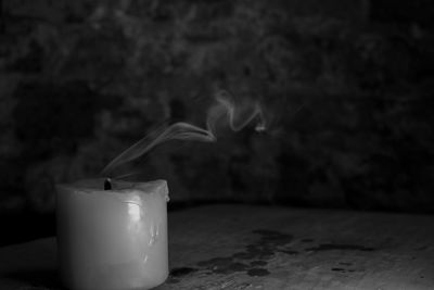 Close-up of candle in darkroom