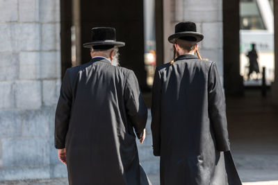 Rear view of man standing in city