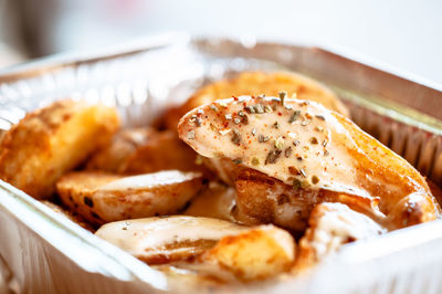 Close-up of baked potato in plate on table