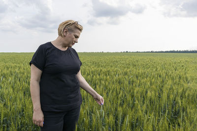 A woman agronomist farmer checks the quality of sowing the crop