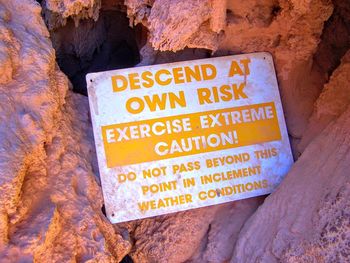 Close-up of information sign on rock