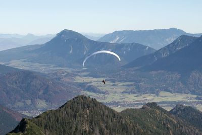 Person paragliding over mountains