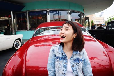 Smiling young woman looking away in car