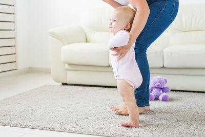 Full length of baby girl on sofa at home