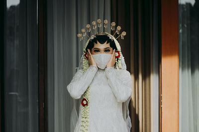 Portrait of bride wearing face mask