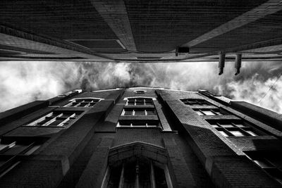 Directly below shot of buildings in city against sky