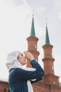 Low angle view of boy against sky