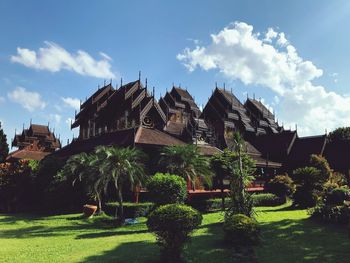 Panoramic view of trees and building against sky