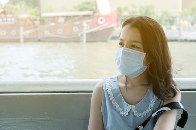 Portrait of young woman sitting outdoors