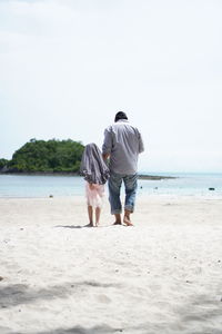 Rear view of couple on beach