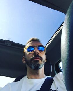 Low angle view of young man in car