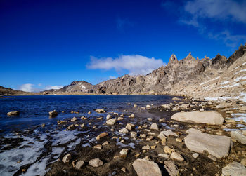 Scenic view of snowcapped mountains against blue sky