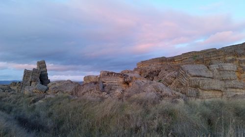 View of cliff against cloudy sky