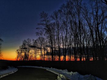 Scenic view of snow covered landscape at sunset