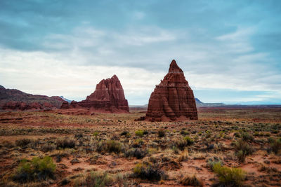 Rock formations on landscape against sky