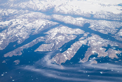 Aerial view of snow covered land and sea