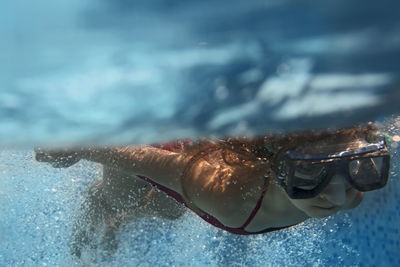 Close-up of girl swimming in pool