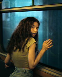 Portrait of young woman in subway train