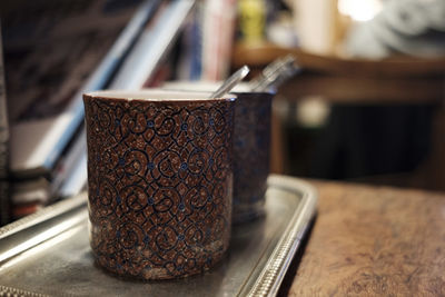 Close-up of cups on table