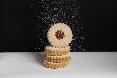 Close-up of cake on table against black background