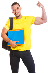 Portrait of smiling young man standing against white background