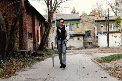 Full length of self-confident retro-styled man walking outdoors.