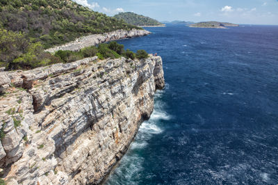 High angle view of rocks on sea against sky