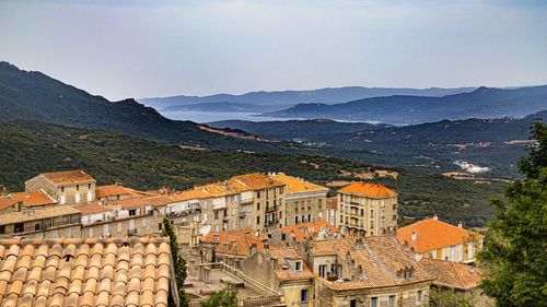 Buildings in town against sky