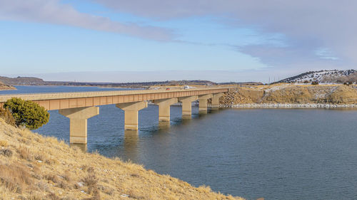 Bridge over sea against sky