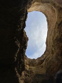 Low angle view of rock formation against sky