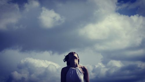 Rear view of woman standing against sky