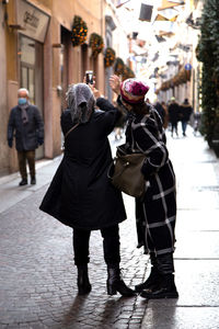 Female friends taking selfie on road